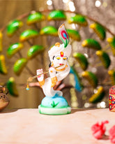 White Krishna Idol on Peacock Feather Base