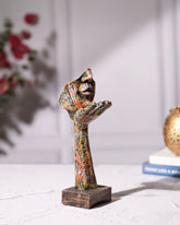Hand Holding Face Sculpture - Multicolour