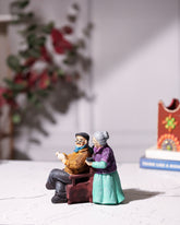 Old Couple Statue Reading Newspaper