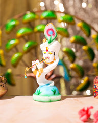 White Krishna Idol on Peacock Feather Base