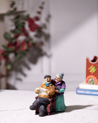 Old Couple Statue Reading Newspaper